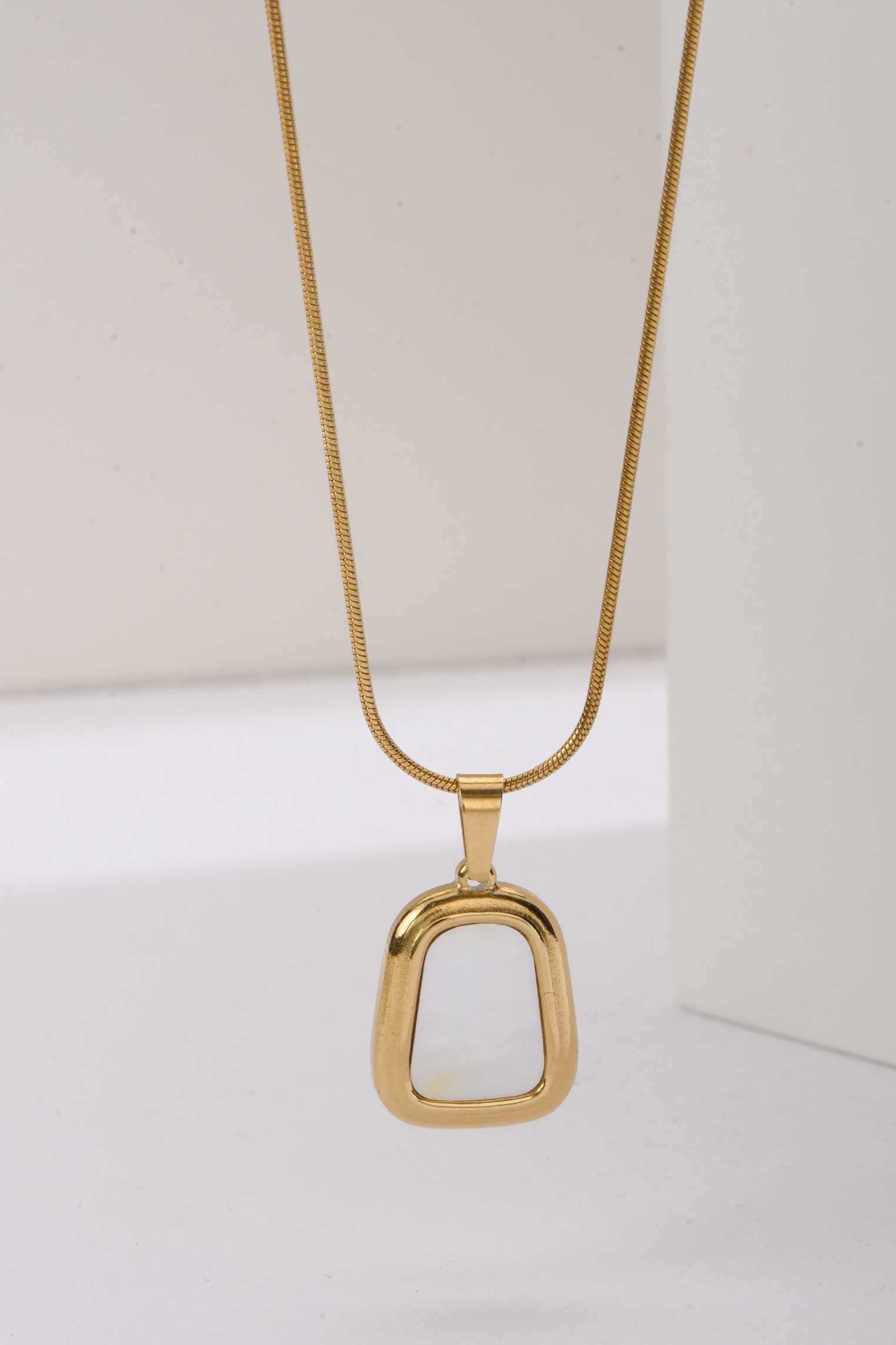 Stainless Steel Necklace | Abstract Gold Pendant with White Enamel Center Accessories Accessories - Cizaro Jeans